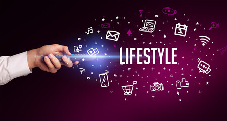 hand holding wireless peripheral with LIFESTYLE inscription, social media concept