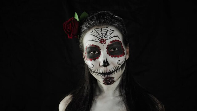Halloween, Day of the Dead. Portrait of a young woman with Calavera Katrina makeup.