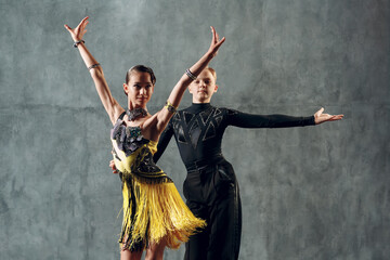 Ballroom dance samba. Young couple in yellow and black costume dancing