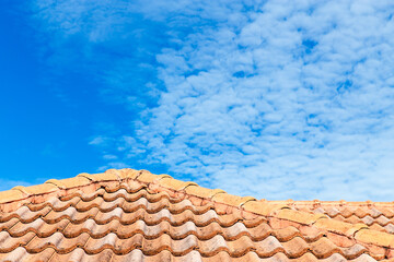 Close up of brown clay roof tiles. Red old dirty roof. Old roof tiles. Construction equipment build a house.