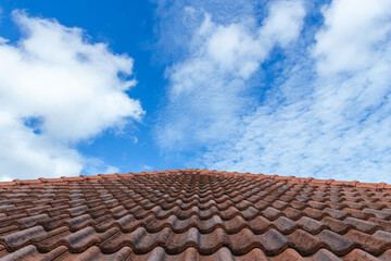 Close up of brown clay roof tiles. Red old dirty roof. Old roof tiles. Construction equipment build a house.