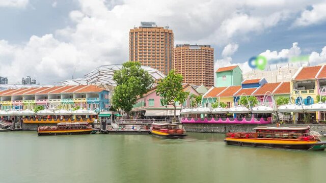 Tourist boats docking at Clarke Quay habour timelapse hyperlapse with colorful houses. Clarke Quay is a historical riverside quay in Singapore, located within the Singapore River Planning Area.