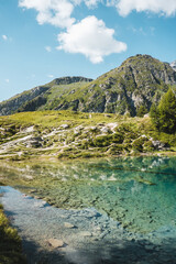 Fototapeta na wymiar Blue lagoon in Switzerland mountains, Valle Verzasca, Lac Bleu