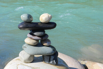 Unusual construction of stones against the background of the river.
