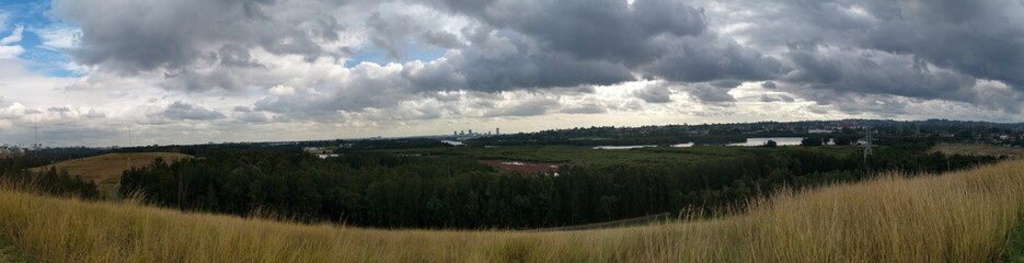Beautiful panoramic view of a park with dark stormy clouds in the sky, Millennium parklands,...