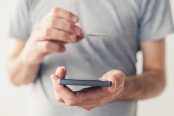 Mobile banking, man using credit card and smartphone app