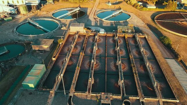 Wide aerial of water purification circle, clean drinking water. Ecosystem of filtration, fresh water and water management. Sewage treatment plant in the sun