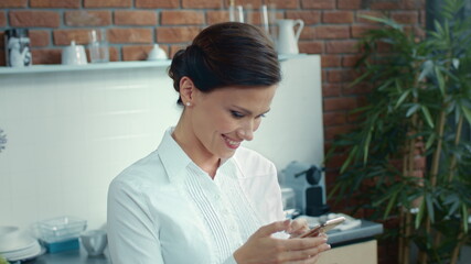 Romantic woman texting message on phone. Joyful girl checking phone content.