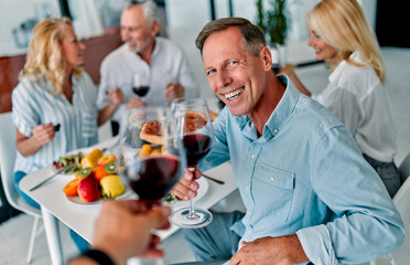 Senior friends having dinner at home