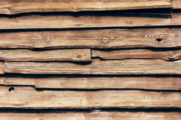 Grunge wood texture. Brown wooden log wall background. Rustic tree desk with knots pattern. Countryside architecture wall. Village building construction.	