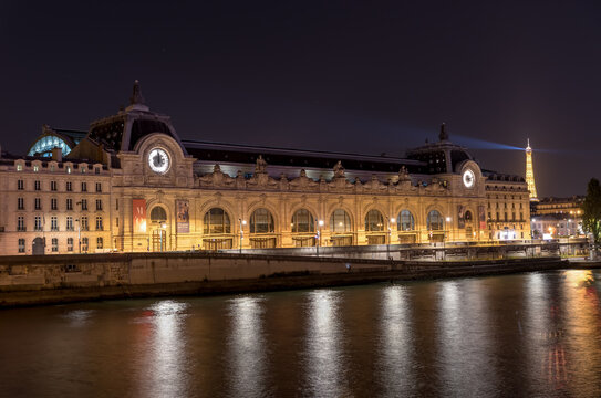 Paris, France - August 15, 2018: Musee d'Orsay with Eiffel tower beam in background at night