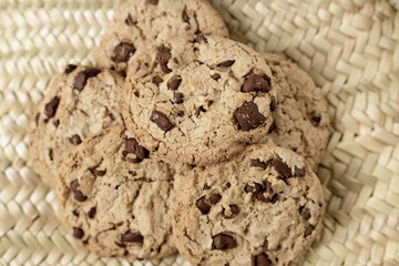 Home made chocolate cookies pile on a natural wicker surfaceCookiesHome made chocolate cookies pile on a natural wicker surface