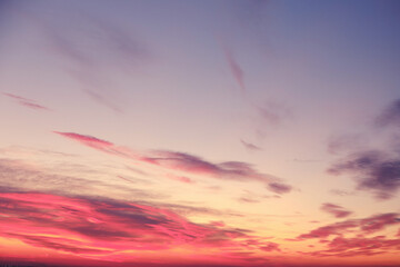 Orange sunset and clouds in the blue sky over the evening city, background