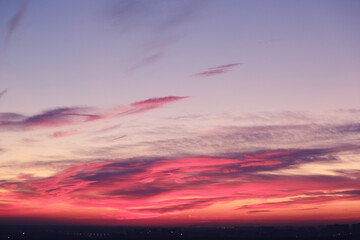 Fototapeta na wymiar Cloudy sky over the building during the orange sunset