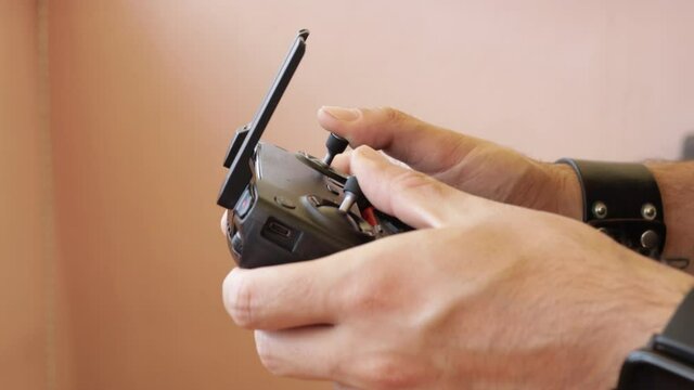 Close up of drone's pilot while filming, rc helicopter's remote controller.Air vehicle transmitter