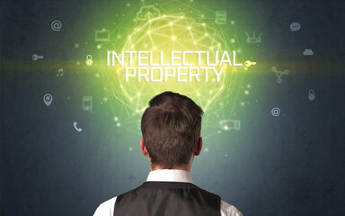 Rear view of a businessman with INTELLECTUAL PROPERTY inscription, online security concept