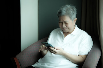 asian senior woman using mobile smart phone. elderly female holding cellphone. mature retirement lifestyle