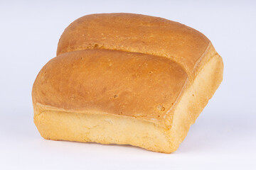 double loaf of fresh wheat bread on a white background