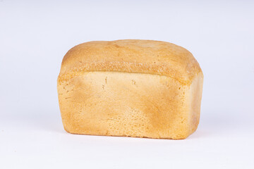 a loaf of fresh wheat bread on a white background
