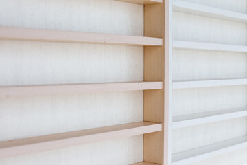 White Wooden Shelf on a Wall in Light Room.