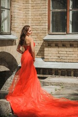 Fototapeta premium Evening dresses concept, elegant fancy style. Woman in evening red dress. Clothes for ladies, inspiration 