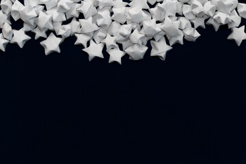 Background from white matte paper stars on a black background located on top and an empty place for text