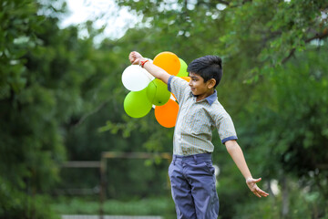 cute little indian boy with tri color balloons and celebrating Independence or Republic day of India