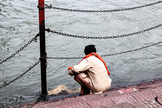 A man washing cloth on the banks of  holy river Ganga. 