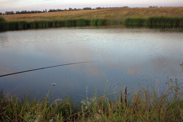 A float rod thrown into the water of a small lake.