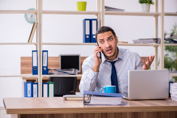 Young male employee unhappy with excessive work