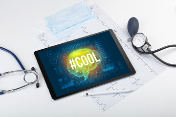 Tablet pc and medical tools with #COOL inscription, social distancing concept