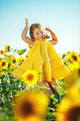 Child in a sunflower field. High quality photo.