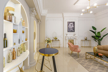chic luxury interior in an old antique style open-plan apartment decorated with columns and stucco on the wall in pastel colors. tiles on the floor. beige walls