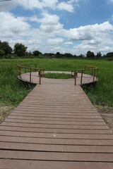 wooden bridge over the river and the field