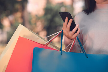 Online shopping saves money, time and helps to relieve the stress. Cropped shot of a lady in white...