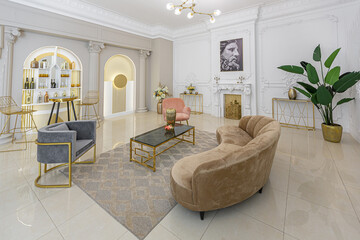 chic luxury interior in an old antique style open-plan apartment decorated with columns and stucco on the wall in pastel colors. tiles on the floor. beige walls