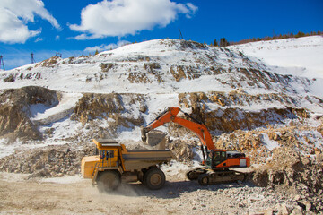 Quarry extraction of silicon. Minerals. Loading and transportation of minerals. Truck and excavator