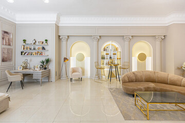 chic luxury interior in an old antique style open-plan apartment decorated with columns and stucco on the wall in pastel colors. tiles on the floor. beige walls