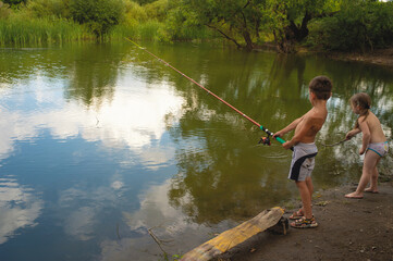 A boy and a girl are fishing.