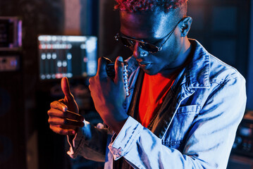Young african american performer rehearsing in a recording studio