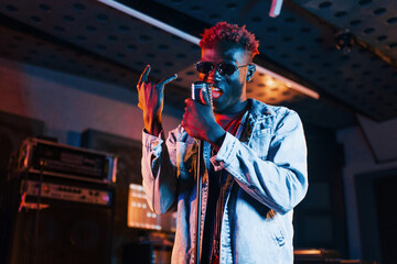 Young african american performer rehearsing in a recording studio