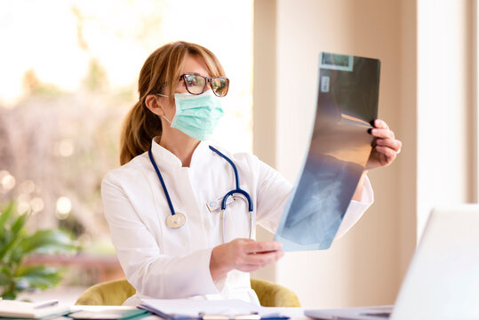 Female doctor analyzing x-ray image