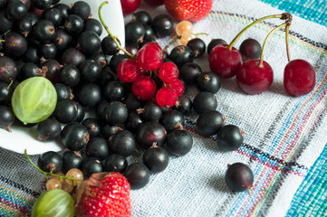 Naklejka na ściany i meble plate of mix berries poured on a napkin