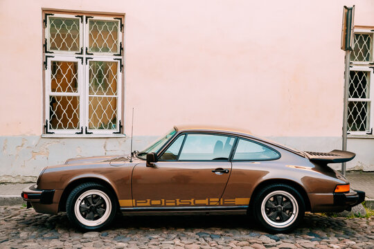 Side View Of Porsche 930 Car Parked In Old Narrow Street.