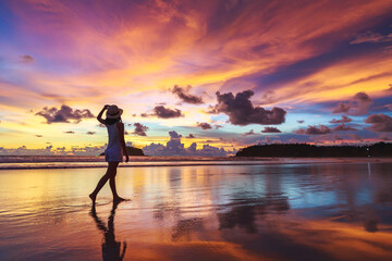 Traveler asian woman travel on Phuket beach in sunset Thailand - obrazy, fototapety, plakaty