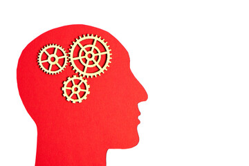 Silhouette of a human head is red with gears inside on a white background.The concept of human thinking.