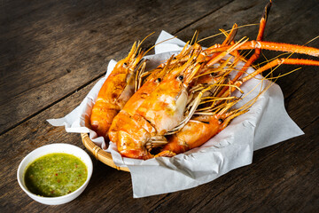 Grilled Shrimp with sauce on wooden table.  Seafood concept
