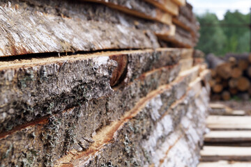 unedged lumber, stacked open air close up