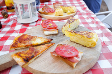 Mediterranean snack in the open air with omelette and pizzas.