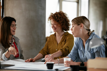 Businesswomen working on a new project. Colleagues discussing about problem they have to solved...